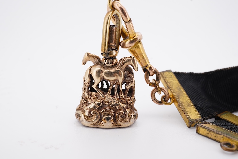 A late Victorian yellow metal overlaid and citrine set watch key fob, depicting two horses and two rams?, 30mm on a black sash suspension, together with a modern pair of 9ct gold and cultured pearl set leaf ear studs. Co